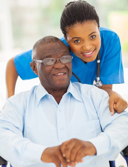 elderly african american man and caring young caregiver at home